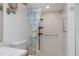 Tiled walk-in shower in bathroom with safety grab bars and curtain featuring beach scenes at 3544 Teeside Dr # 1, New Port Richey, FL 34655