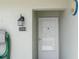 Close-up of front door, displaying house number and outdoor lighting fixture at 3544 Teeside Dr # 1, New Port Richey, FL 34655