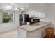 Eat-in kitchen features stainless refrigerator, range, and bright window view at 3544 Teeside Dr # 1, New Port Richey, FL 34655