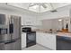 Kitchen boasts stainless steel refrigerator, range, and white cabinetry at 3544 Teeside Dr # 1, New Port Richey, FL 34655