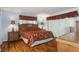 Main bedroom features hardwood floors, bamboo furniture, and a window view at 3544 Teeside Dr # 1, New Port Richey, FL 34655