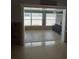 Open living room with tile floors and exterior access at 406 Driftwood E Dr, Palm Harbor, FL 34683