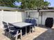 Backyard with outdoor table and chairs under a pergola with a grill and counter at 406 Driftwood E Dr, Palm Harbor, FL 34683