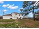 Wide backyard showcasing a patio, BBQ, dining set, and lush green space at 4148 Landover Blvd, Spring Hill, FL 34609