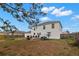Spacious backyard featuring a patio, BBQ, dining area, and well-maintained lawn at 4148 Landover Blvd, Spring Hill, FL 34609