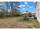 Large, partially-shaded backyard, with a dining area and BBQ at 4148 Landover Blvd, Spring Hill, FL 34609