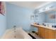 Bathroom featuring a soaking tub, vanity with sink, and ample lighting for a spa-like experience at 4148 Landover Blvd, Spring Hill, FL 34609