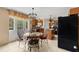Eat-in kitchen with a round table, wooden cabinets, and a door leading to the backyard at 4148 Landover Blvd, Spring Hill, FL 34609