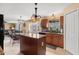 Well-lit kitchen with an island, wooden cabinets, and access to an adjacent dining area at 4148 Landover Blvd, Spring Hill, FL 34609