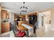 Bright kitchen with a center island, wooden cabinetry, and an adjacent dining area at 4148 Landover Blvd, Spring Hill, FL 34609