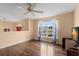 Well-lit room with wood-look floors, a window, and an arched opening, creating a welcoming atmosphere at 4148 Landover Blvd, Spring Hill, FL 34609