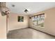 Cozy living room with wood floors, neutral walls, and a large window offering a bright view at 4148 Landover Blvd, Spring Hill, FL 34609