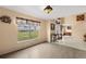 Cozy living room with wood floors, neutral walls, and a large window offering a bright view at 4148 Landover Blvd, Spring Hill, FL 34609