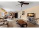 Bright living room with tile floors and a view of the kitchen and dining area at 4148 Landover Blvd, Spring Hill, FL 34609