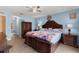 Cozy main bedroom with ample natural light, wood-look floors, and a ceiling fan for added comfort at 4148 Landover Blvd, Spring Hill, FL 34609