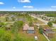 Expansive aerial view of a home featuring a private pool, spacious yard, and convenient access to nearby shops and restaurants at 4190 Lema Dr, Spring Hill, FL 34609
