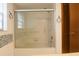 Bathroom featuring tiled shower with glass sliding doors, and a tiled wall feature at 4190 Lema Dr, Spring Hill, FL 34609