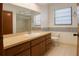 Bathroom featuring a vanity with drawers, a large mirror, a tiled backsplash and a shower-tub combo at 4190 Lema Dr, Spring Hill, FL 34609