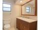 Bathroom with wood vanity, a modern sink, and a large framed mirror at 4190 Lema Dr, Spring Hill, FL 34609
