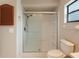 Modern bathroom with glass-enclosed shower, tiled walls, and neutral finishes at 4190 Lema Dr, Spring Hill, FL 34609