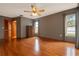 Primary bedroom with hardwood floors, closet and large windows for ample natural light at 4190 Lema Dr, Spring Hill, FL 34609