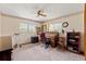 Bright bedroom featuring a classic roll-top desk and ample natural light from two large windows at 4190 Lema Dr, Spring Hill, FL 34609