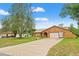 Lovely home features manicured lawn, concrete driveway, arched entryway, stucco exterior and a two-car garage at 4190 Lema Dr, Spring Hill, FL 34609