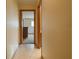 Hallway featuring tile flooring and views into a bedroom with natural light at 4190 Lema Dr, Spring Hill, FL 34609