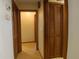 Hallway view featuring tile flooring and wood doors leading to other rooms at 4190 Lema Dr, Spring Hill, FL 34609