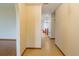 Hallway with tile flooring leading to an arched entry and features a glimpse of the dining area and stairs at 4190 Lema Dr, Spring Hill, FL 34609