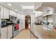 Bright kitchen featuring granite countertops, stainless steel appliances, and ample cabinet storage at 4190 Lema Dr, Spring Hill, FL 34609