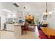 Bright open-concept kitchen that flows into a living area with a stone fireplace and dining table at 4190 Lema Dr, Spring Hill, FL 34609
