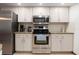 Well-equipped kitchen with stainless steel appliances and bright white cabinets at 4190 Lema Dr, Spring Hill, FL 34609