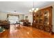 Cozy living room with hardwood floors, a vintage china cabinet, and ample natural light at 4190 Lema Dr, Spring Hill, FL 34609