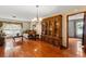 Elegant living room with hardwood floors, a large china cabinet, and a bright window at 4190 Lema Dr, Spring Hill, FL 34609