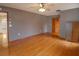 Spacious living room with hardwood floors, fresh paint, and a ceiling fan offers a comfortable and inviting space at 4190 Lema Dr, Spring Hill, FL 34609