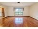 Inviting living room with hardwood floors and large window overlooking a well-manicured lawn at 4190 Lema Dr, Spring Hill, FL 34609