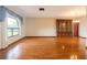 Bright living room with hardwood floors and a large window for plenty of natural light at 4190 Lema Dr, Spring Hill, FL 34609