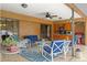 Covered patio featuring comfortable seating and an outdoor kitchen area overlooking the backyard at 4190 Lema Dr, Spring Hill, FL 34609