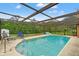 Inviting screened-in pool area with comfortable lounge seating and serene backyard views at 4190 Lema Dr, Spring Hill, FL 34609