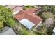 Aerial shot of the home highlighting the roof, screened patio, mature trees, and well-maintained landscaping at 4420 Marine Pkwy, New Port Richey, FL 34652