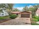 A well-maintained single-story home with a brown roof, two-car garage, and established landscaping at 4420 Marine Pkwy, New Port Richey, FL 34652