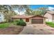 Inviting single-story home with a brown roof, two-car garage, and attractive front yard shrubbery at 4420 Marine Pkwy, New Port Richey, FL 34652