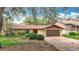 Charming single-story home featuring a brown roof, two-car garage, and front yard landscaping at 4420 Marine Pkwy, New Port Richey, FL 34652