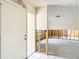 Entryway with white door, tile floor, exposed wall studs, and view into an unfinished room at 4420 Marine Pkwy, New Port Richey, FL 34652