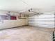 Garage interior featuring large garage door and electric panel ready for renovation at 4420 Marine Pkwy, New Port Richey, FL 34652
