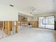 Bright living room showcasing open floor plan, sliding glass doors to patio and ceiling fan at 4420 Marine Pkwy, New Port Richey, FL 34652