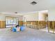 Bright living area featuring wall studs ready for customization and sliding door access to the outside at 4420 Marine Pkwy, New Port Richey, FL 34652