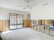 Living room with sliding glass door to screened lanai, ceiling fan and open space at 4420 Marine Pkwy, New Port Richey, FL 34652
