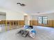 Open space with wall studs prepared for renovation and a window allowing natural light at 4420 Marine Pkwy, New Port Richey, FL 34652